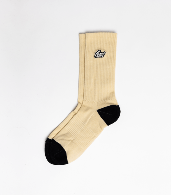 light brown sport socks with black heel and toes and logo embroidered on the side