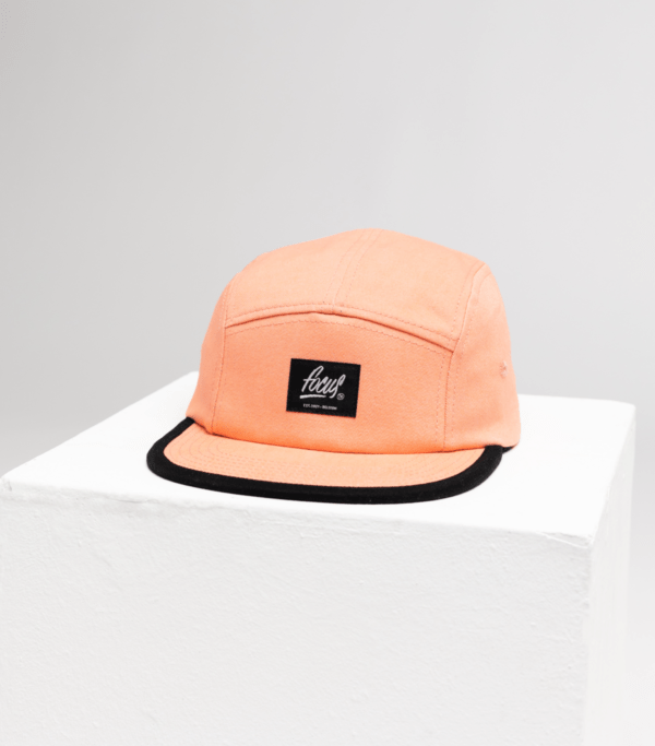 pink 5 panel cap on white cube
