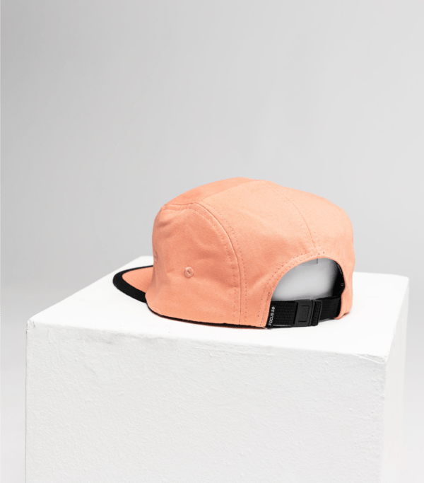 back pink 5 panel cap on white cube